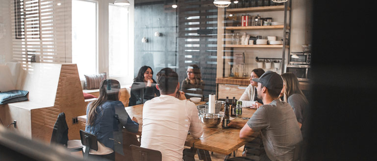 Workplace meeting with happy work colleagues.